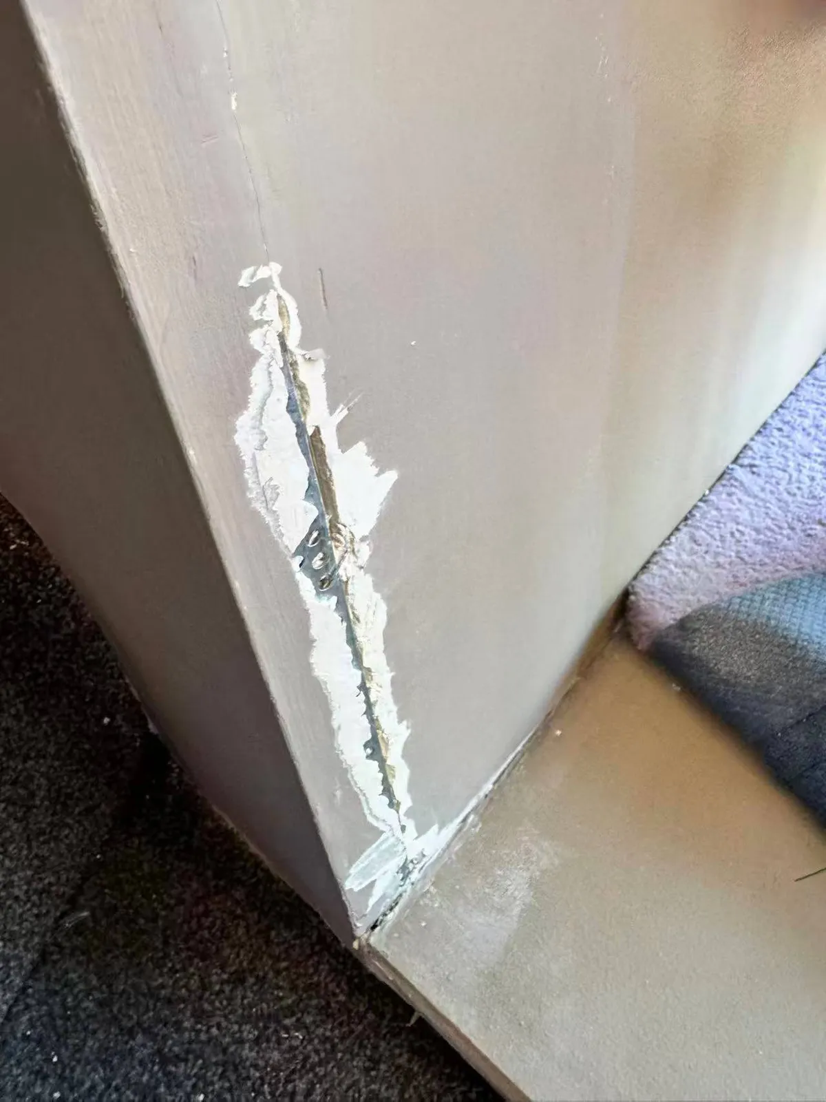 Before: damaged plaster at a wall corner